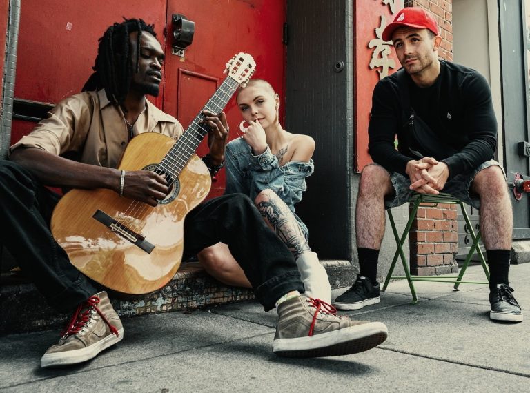Two Men and Woman Sitting Next to Each Other